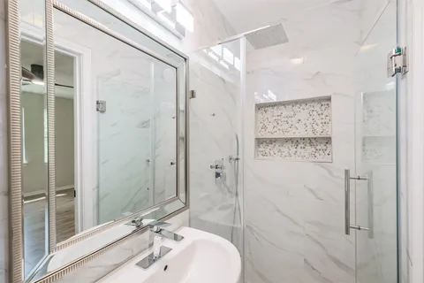 a bathroom with a shower and a sink