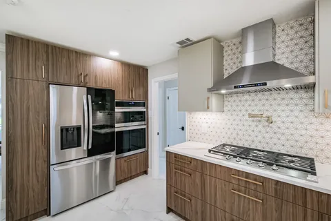 a kitchen with stainless steel appliances granite countertop a stove and a refrigerator