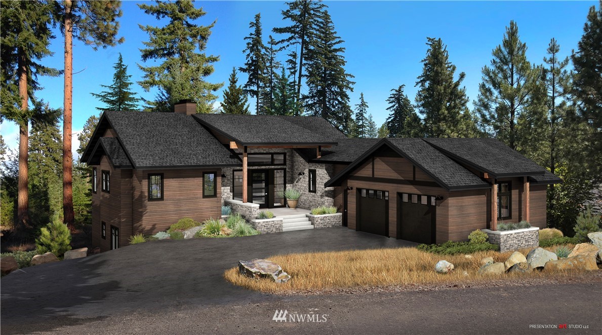 320 Kokanee Loop Cle Elum, WA 98922 - Photo 1 of 14 a front view of a house with a yard and garage