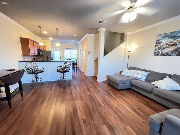 a living room with furniture and wooden floor