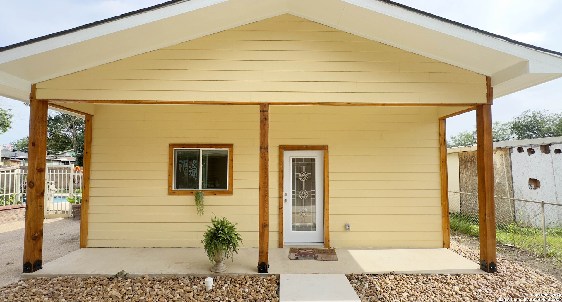 a front view of a house with a garden