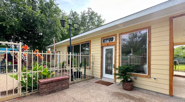 a view of a house with a yard patio and swimming pool