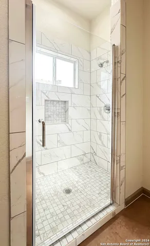 a view of a chair and tables in the back yard of the house