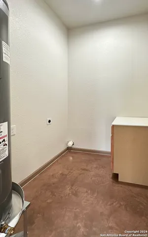 a view of a backyard with table and chairs potted plants and wooden fence