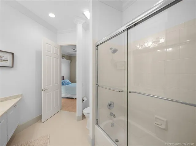 a bathroom with a glass shower door and a sink