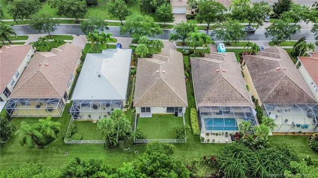 an aerial view of multiple houses with a yard