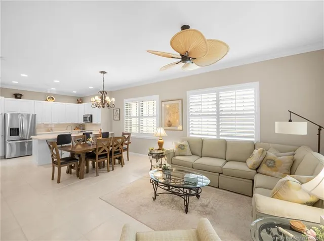 a living room with furniture a rug and a large window