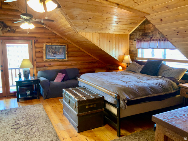76 Highway 118 Monroe, UT 84754 - Photo 35 of 76 Bedroom with multiple windows, wood ceiling, light wood-type flooring, rustic walls, and vaulted ceiling