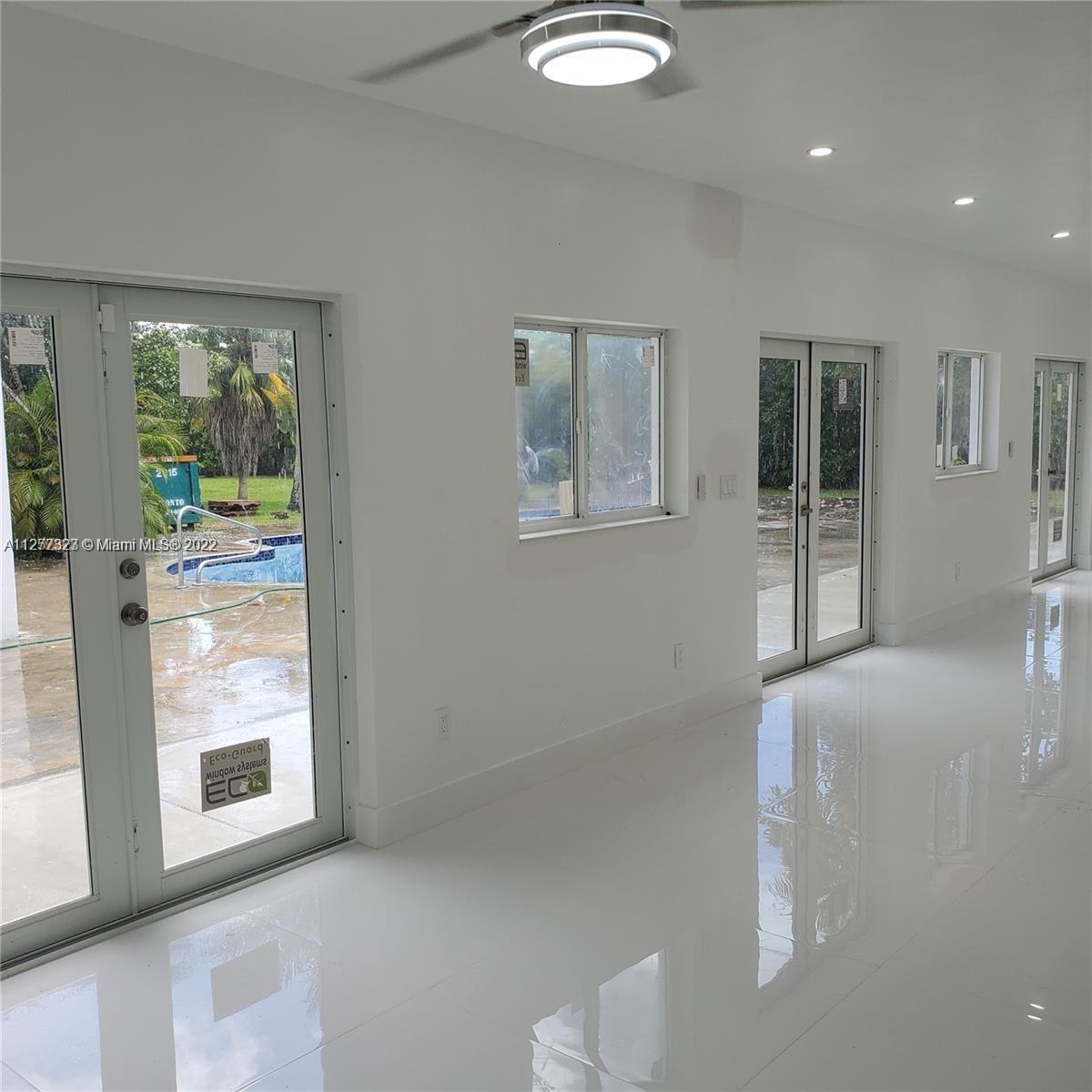 35220 Southwest 213th Avenue Homestead, FL 33034 - Photo 22 of 46 LOBBY/ENTAIMENT AREA WITH POOL VIEW