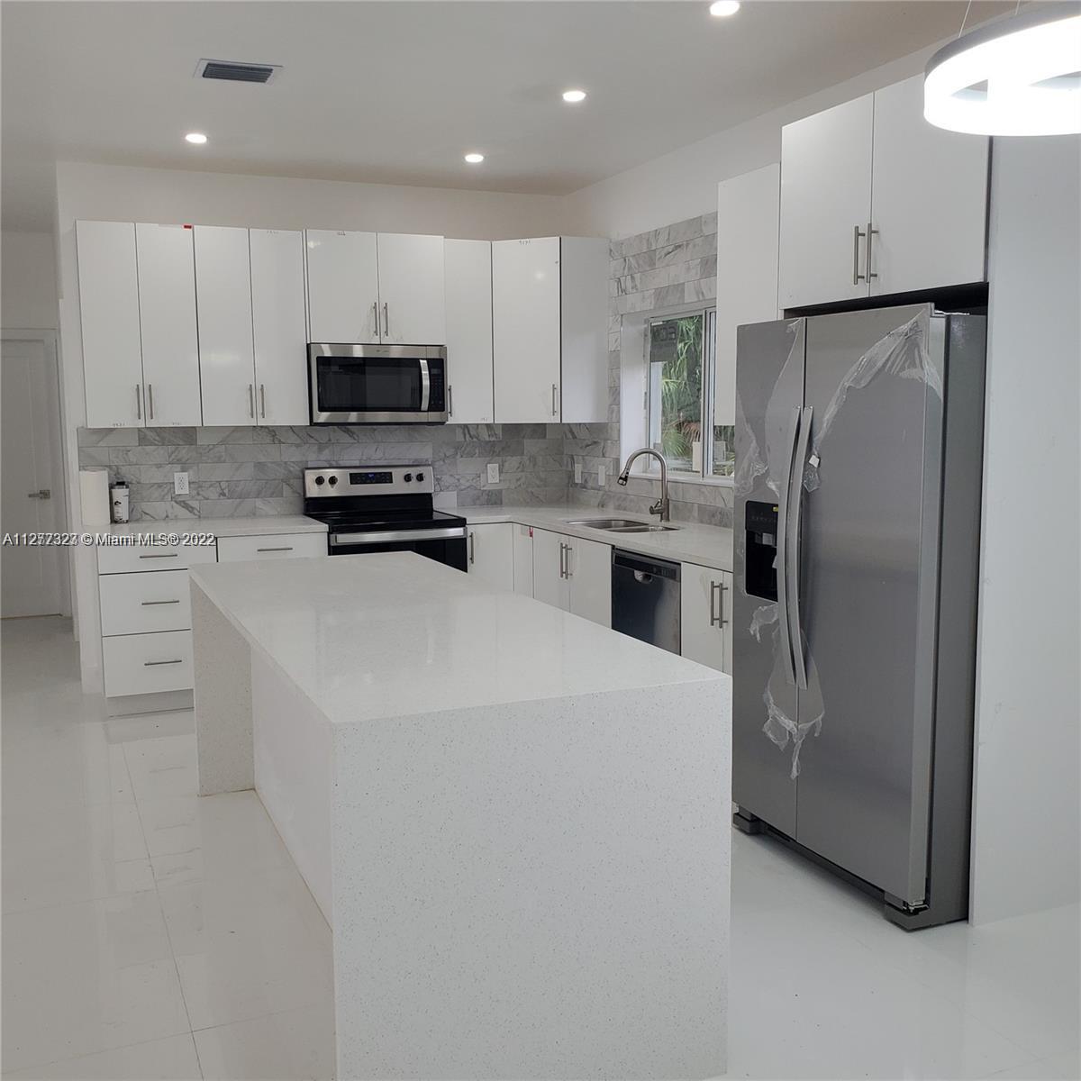 35220 Southwest 213th Avenue Homestead, FL 33034 - Photo 28 of 46 KITCHEN WITH QUARTZ COUNTERTOPS