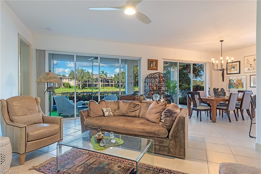 745 Regency Reserve Circle, Unit 5202 Naples, FL 34119 - Photo 3 of 14 a living room with furniture and a large window