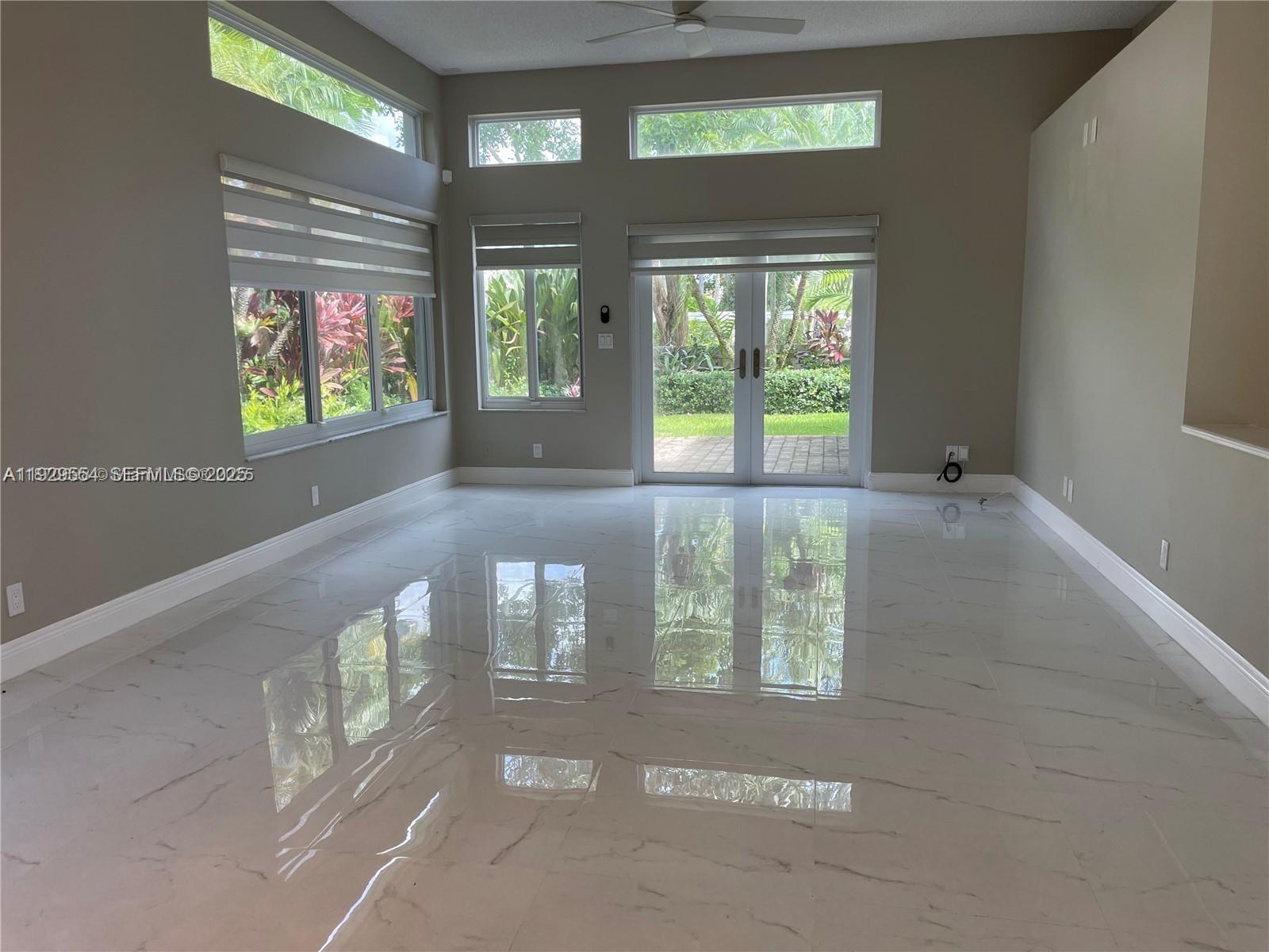 10101 Northwest 5th Street, Unit 10101 Plantation, FL 33324 - Photo 12 of 29 a view of an empty room with windows