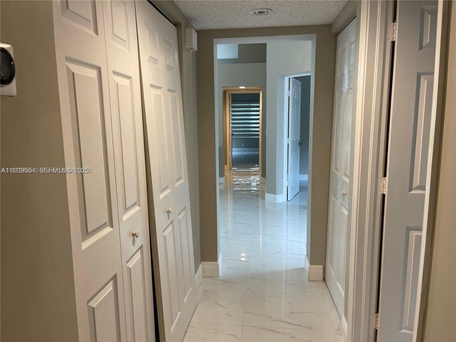 10101 Northwest 5th Street, Unit 10101 Plantation, FL 33324 - Photo 13 of 29 a view of a bathroom from a hallway
