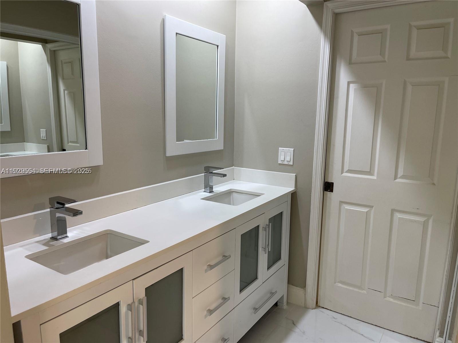 10101 Northwest 5th Street, Unit 10101 Plantation, FL 33324 - Photo 17 of 29 a bathroom with a sink and a mirror