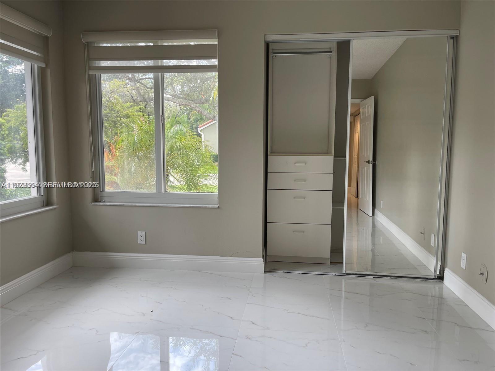 10101 Northwest 5th Street, Unit 10101 Plantation, FL 33324 - Photo 20 of 29 an empty room with windows and closet