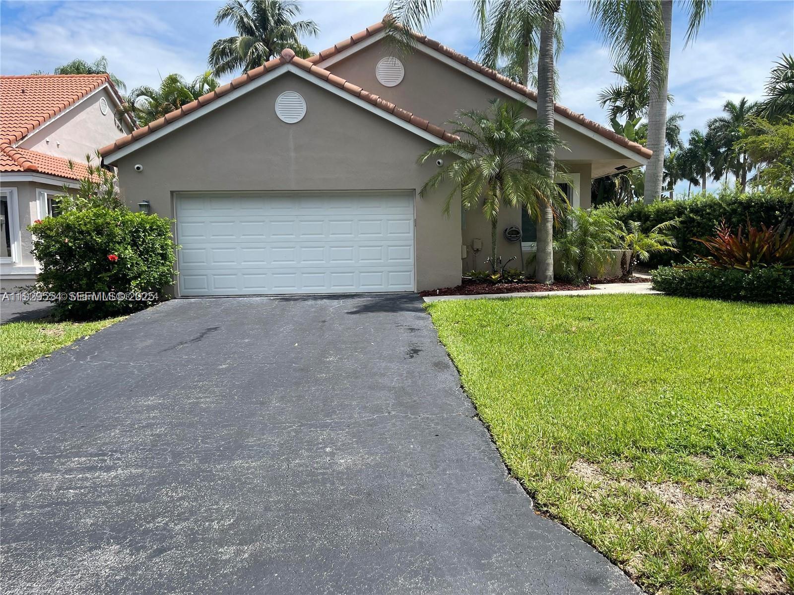 10101 Northwest 5th Street, Unit 10101 Plantation, FL 33324 - Photo 2 of 29 a front view of house with yard and green space