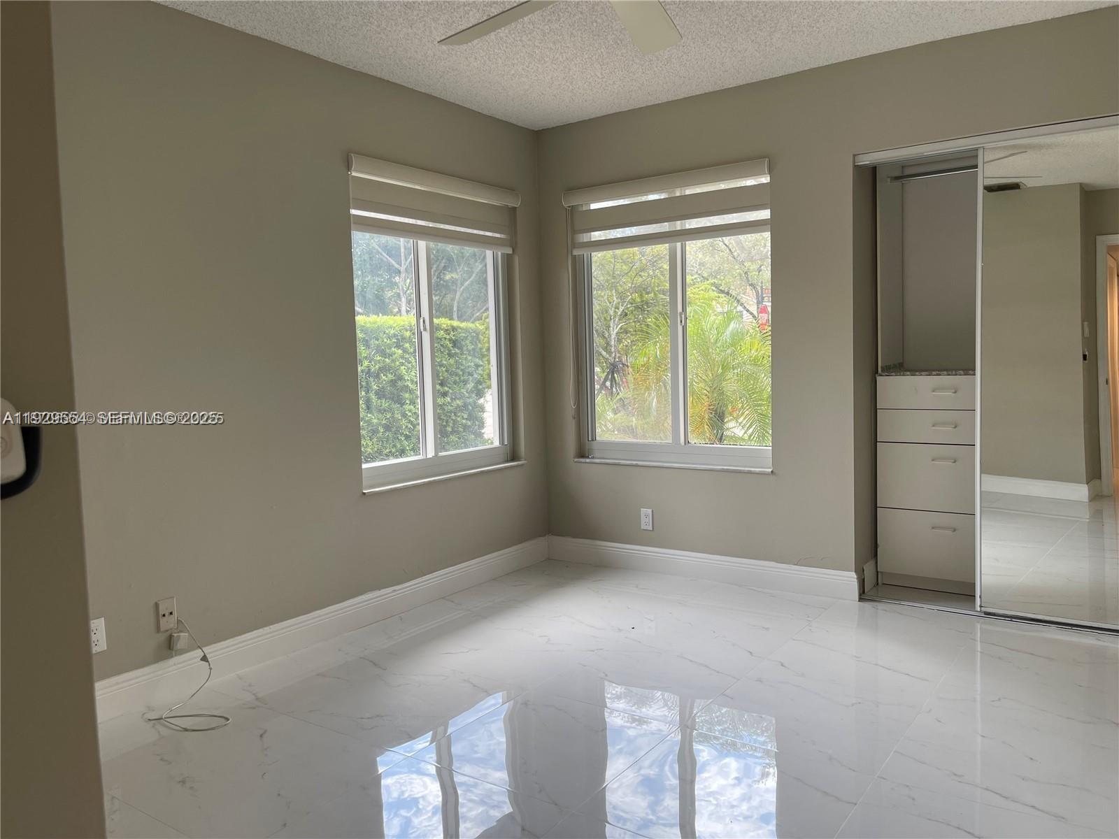 10101 Northwest 5th Street, Unit 10101 Plantation, FL 33324 - Photo 21 of 29 an empty room with windows
