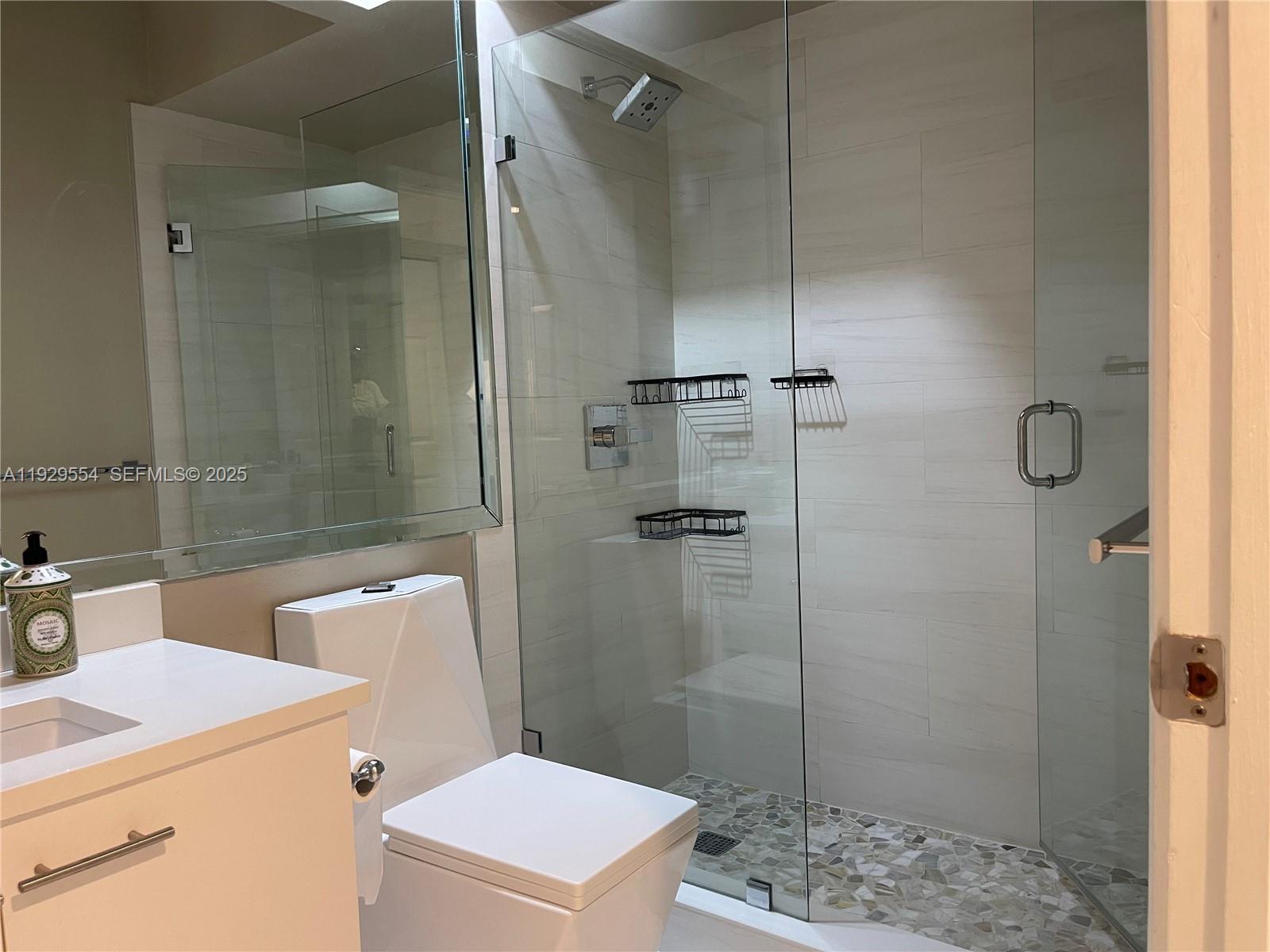10101 Northwest 5th Street, Unit 10101 Plantation, FL 33324 - Photo 23 of 29 a bathroom with a shower a toilet and sink
