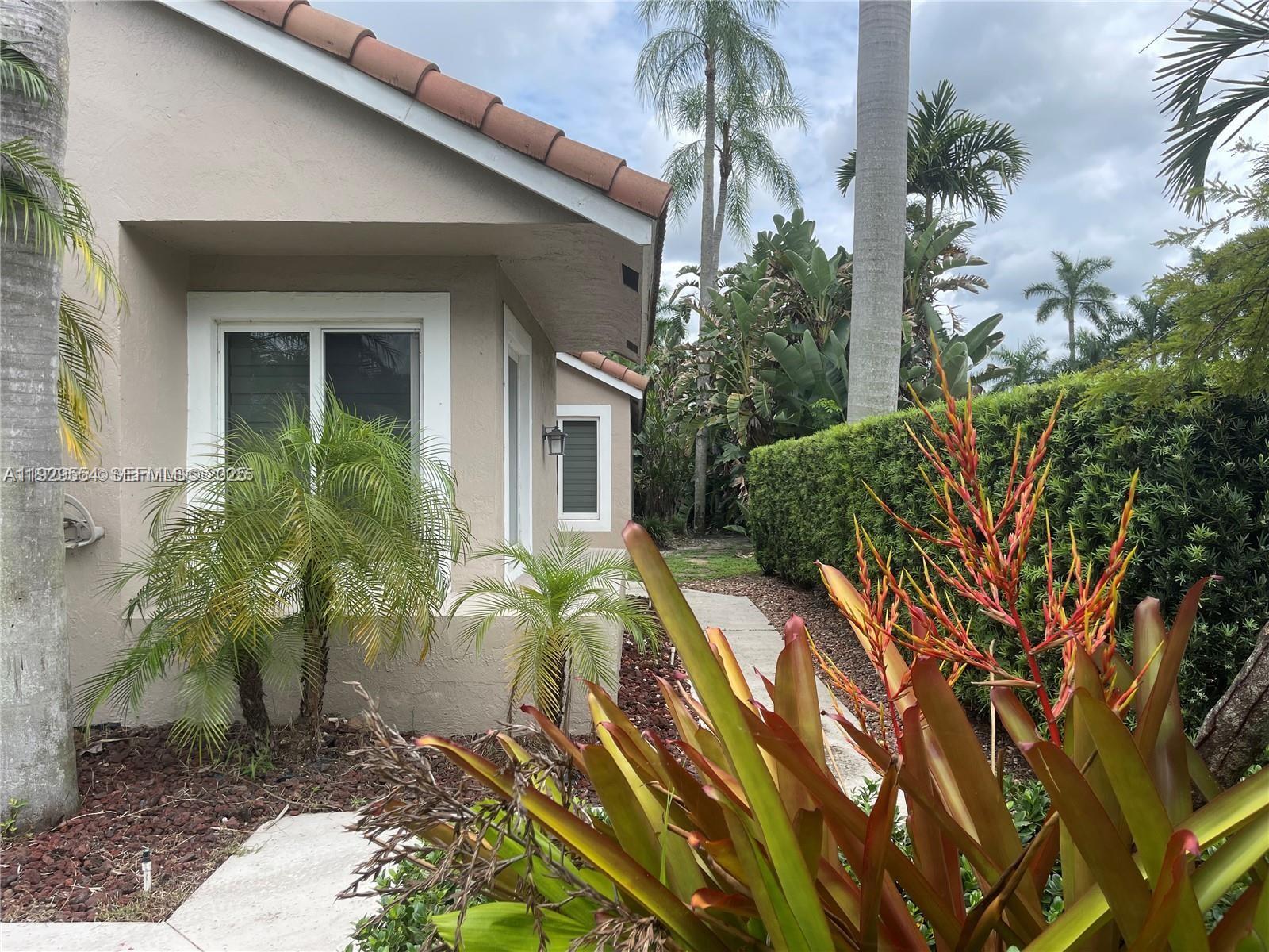 10101 Northwest 5th Street, Unit 10101 Plantation, FL 33324 - Photo 3 of 29 a view of a house with a yard