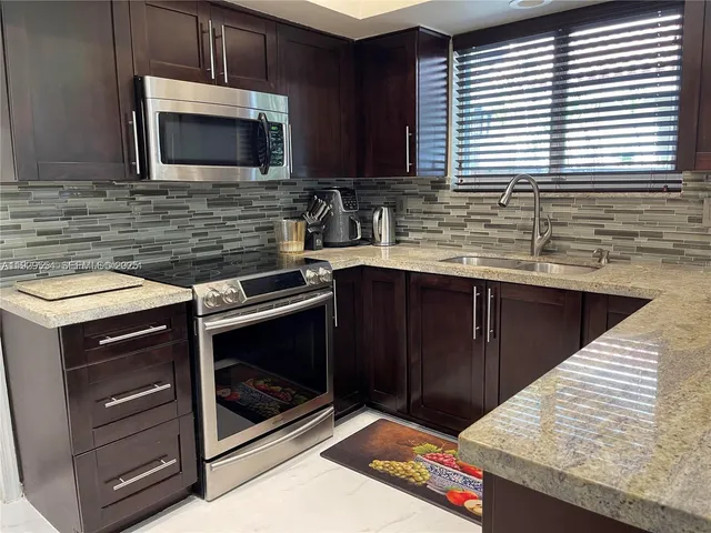 a kitchen with a stove microwave and sink