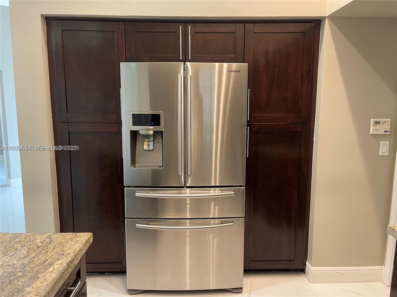 10101 Northwest 5th Street, Unit 10101 Plantation, FL 33324 - Photo 10 of 29 a refrigerator freezer sitting in a kitchen