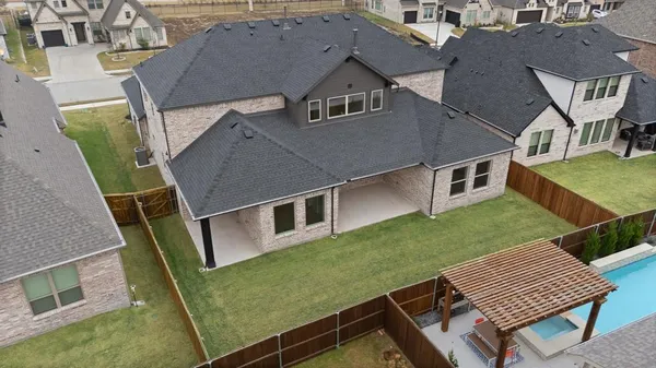an aerial view of a house with backyard