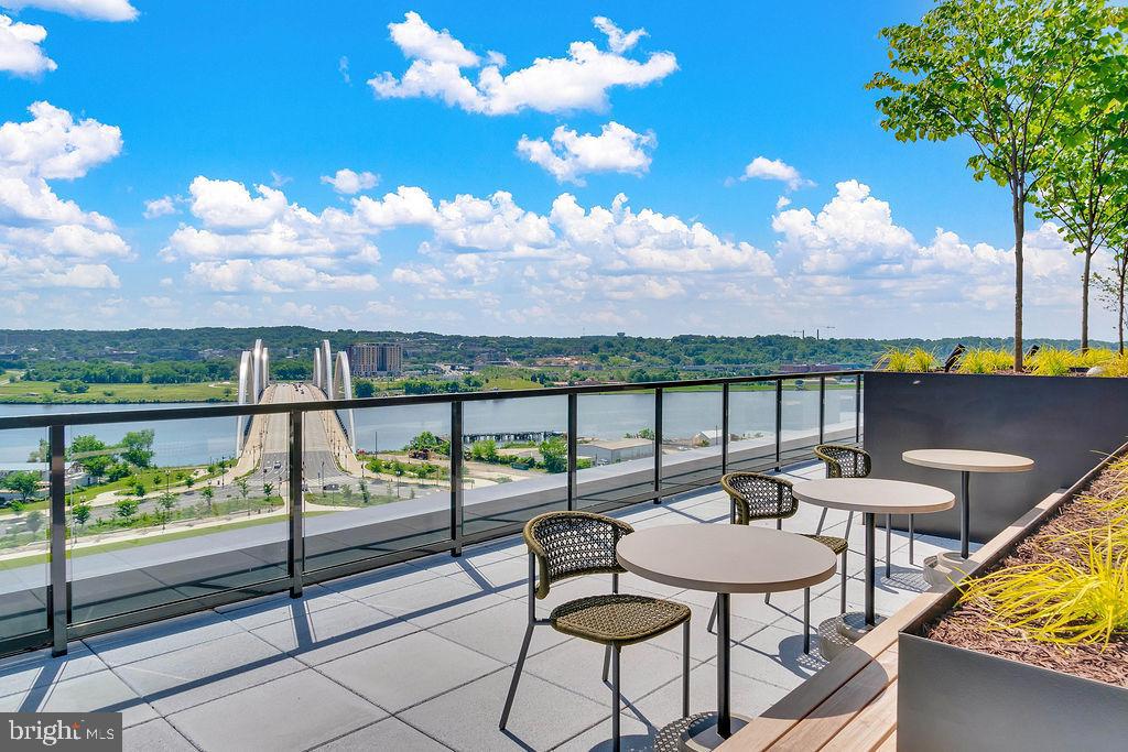 113 Potomac Avenue Southwest, Unit 1100 Washington, DC 20024 - Photo 7 of 50 a balcony with table and chairs