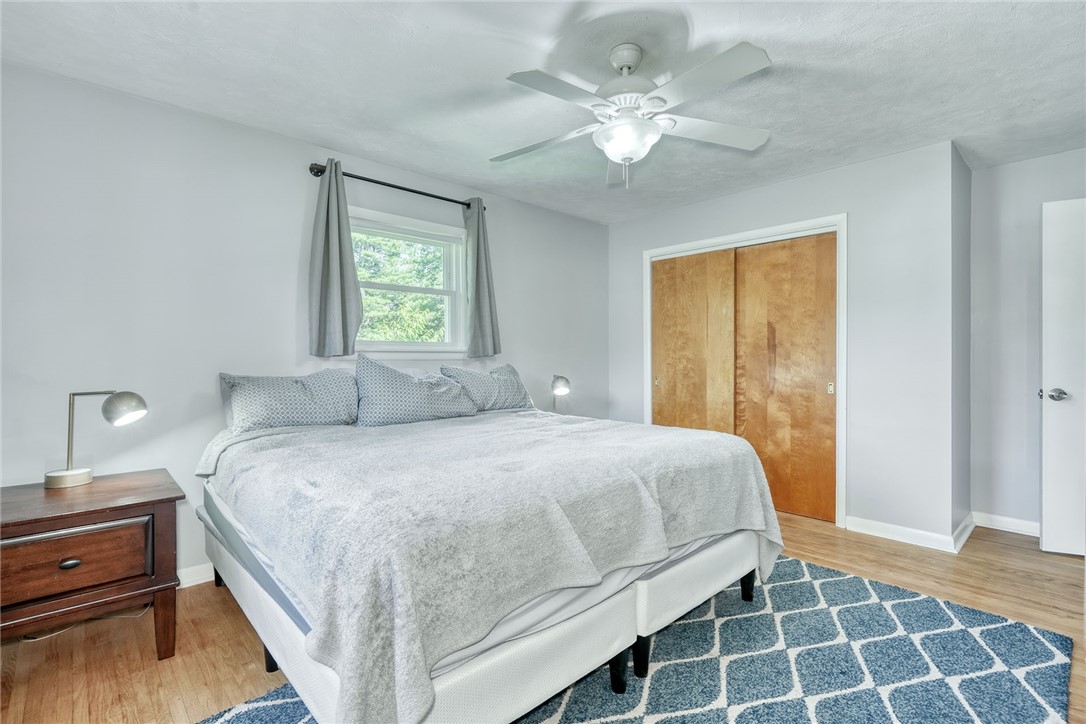 1038 Whalen Road Penfield, NY 14526 - Photo 23 of 46 Primary bedroom with ceiling, fan and hardwood flo