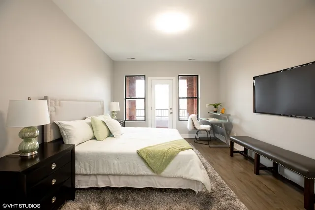 a bedroom with a bed and a flat screen tv