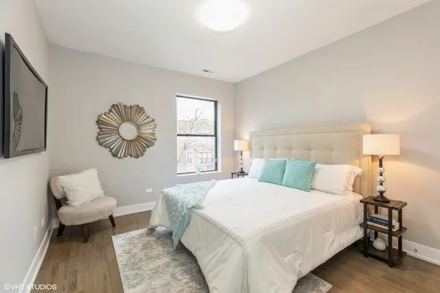 a bedroom with a bed and a lamp with window