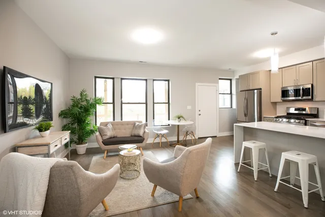 a living room with furniture a flat screen tv and a large window