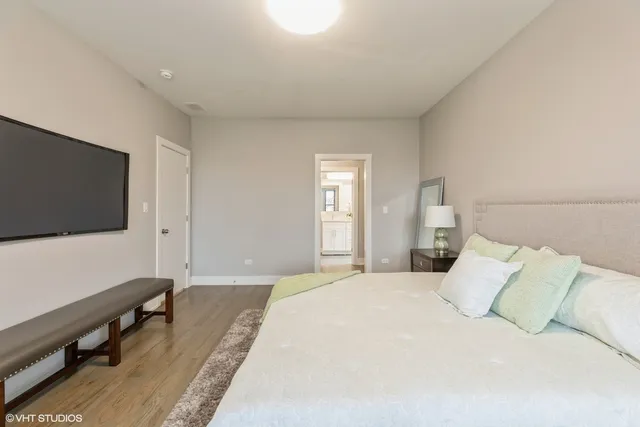 a bedroom with a bed and a flat screen tv