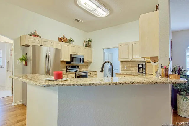 a kitchen with appliances cabinets and furniture