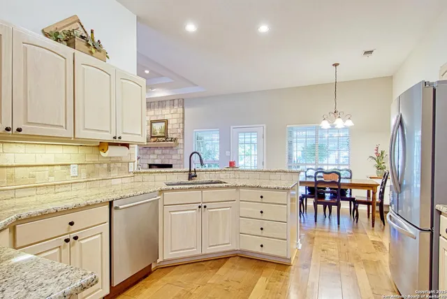 a kitchen with white cabinets sink and white appliances