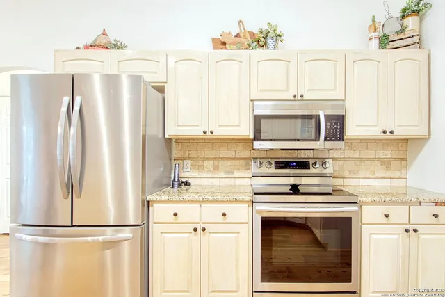 a kitchen with a refrigerator and a sink