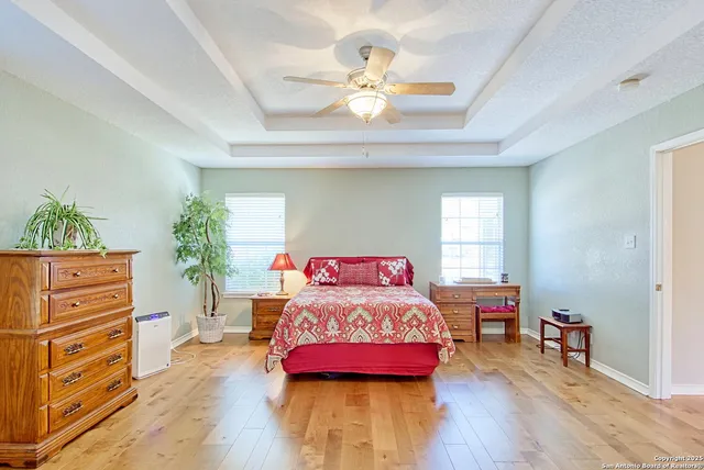 a bathroom with a tub shower and window