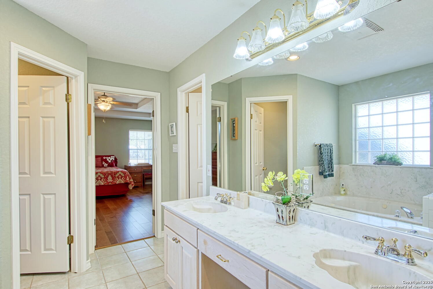 15260 Miller Road St. Hedwig, TX 78152 - Photo 31 of 48 a en suite bathroom with a granite countertop sink and a mirror