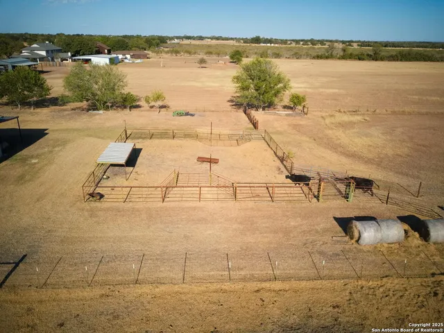 an aerial view of a residential houses with outdoor space