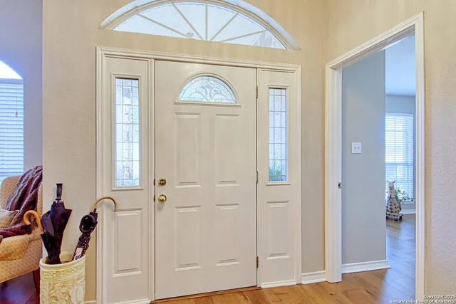 a living room with furniture a fireplace and a potted plant