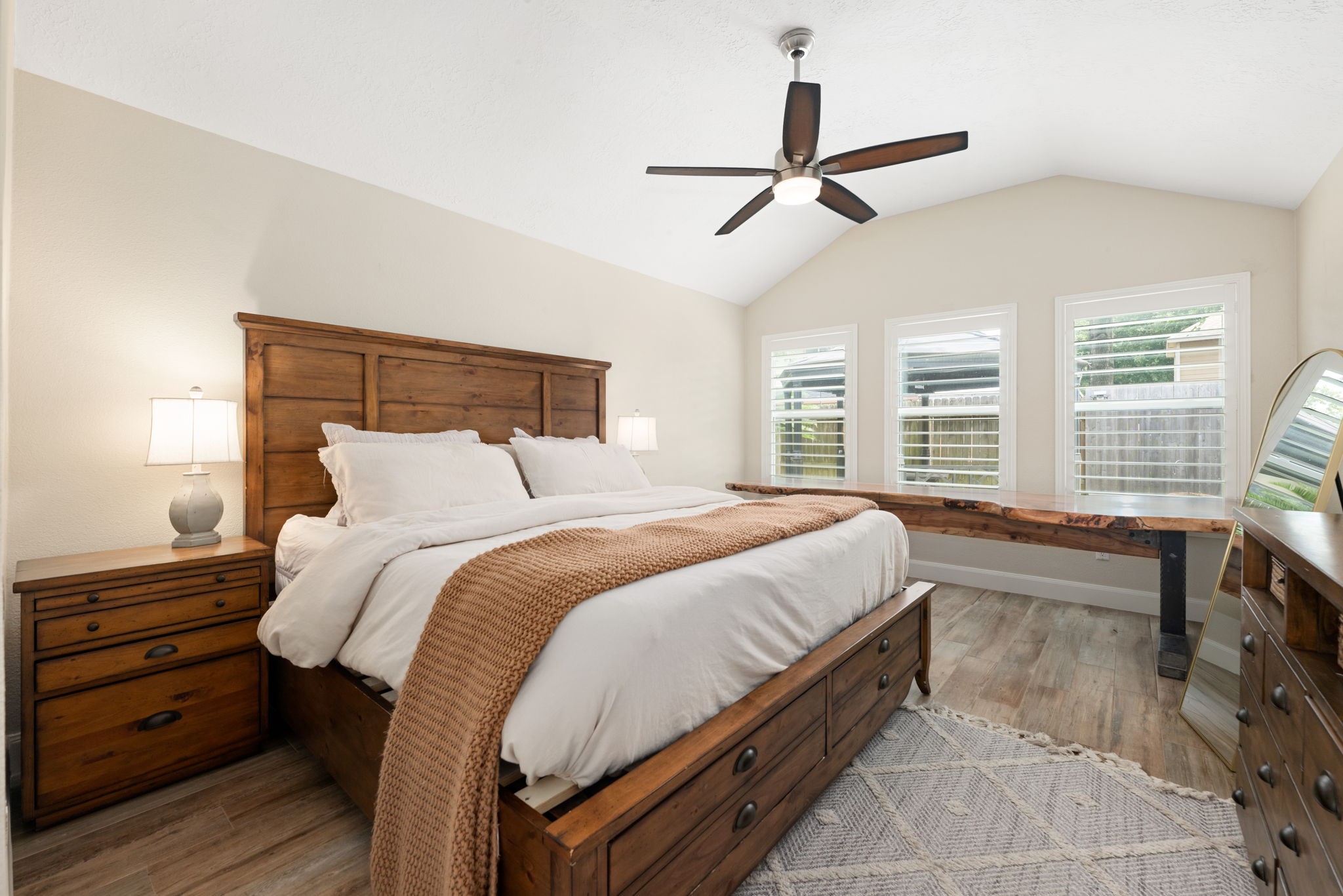 1915 Mercoal Drive Spring, TX 77386 - Photo 16 of 50 Spacious primary bedroom with large windows, plush carpeting, and abundant natural light.
