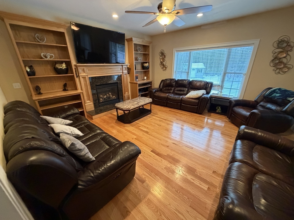 17 Two Ponds Road Belchertown, MA 01007 - Photo 17 of 23 a living room with furniture a flat screen tv and a fireplace