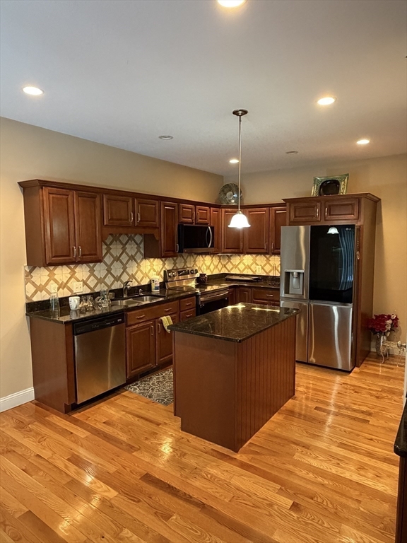 17 Two Ponds Road Belchertown, MA 01007 - Photo 18 of 23 a kitchen with stainless steel appliances kitchen island granite countertop a stove and refrigerator