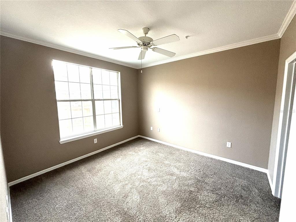 4221 West Spruce Street, Unit 1418 Tampa, FL 33607 - Photo 13 of 22 an empty room with a window and a fan