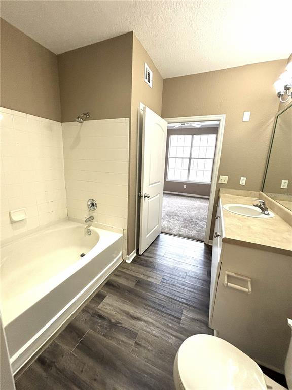 4221 West Spruce Street, Unit 1418 Tampa, FL 33607 - Photo 14 of 22 a bathroom with a granite countertop toilet a sink and bathtub