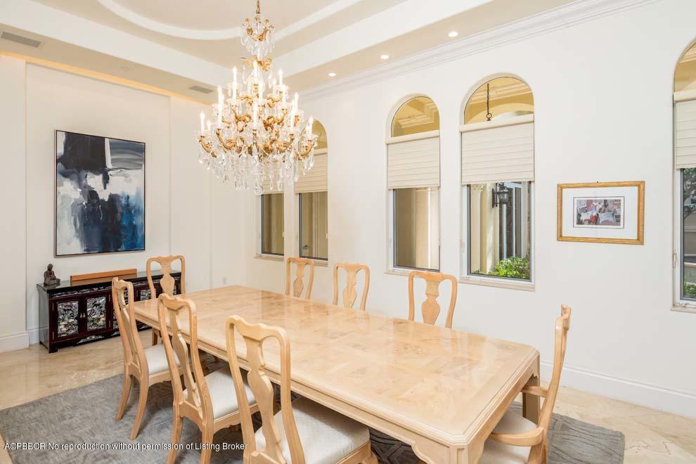 465 Northeast Spanish Trail Boca Raton, FL 33432 - Photo 14 of 35 a dining room with chandelier and wooden floor