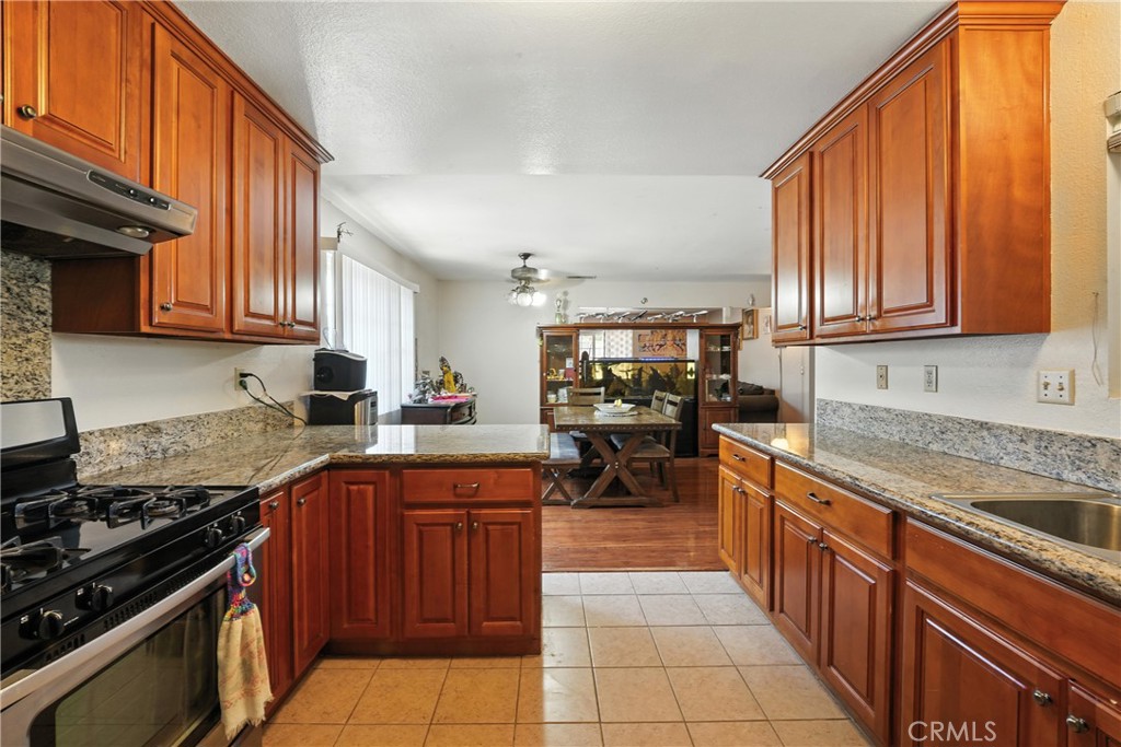 11813 Colima Road Whittier, CA 90604 - Photo 8 of 19 a kitchen with stainless steel appliances granite countertop a sink stove and refrigerator