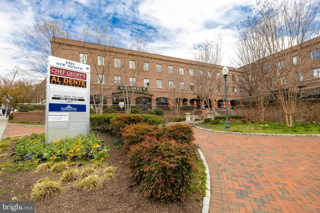 a front view of a house with swimming pool and sitting area