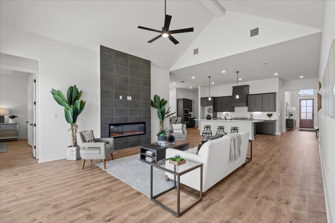 231 Begonia Street Buda, TX 78610 - Photo 15 of 27 a living room with furniture and a kitchen view