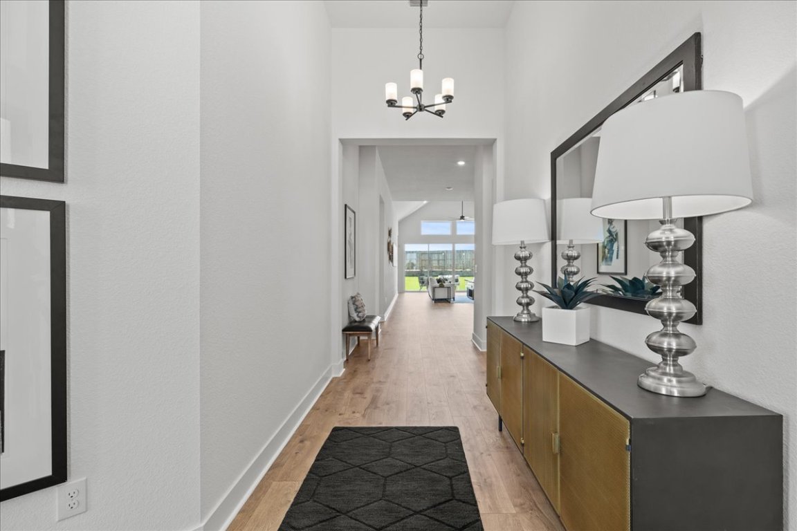 231 Begonia Street Buda, TX 78610 - Photo 17 of 27 a hallway with a sink and a mirror