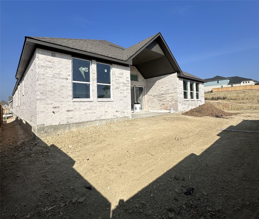 231 Begonia Street Buda, TX 78610 - Photo 2 of 27 a front view of a house with a yard